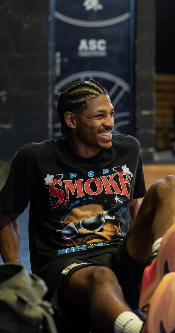 Niels Montabord, grand sourire, en t-shirt noir pendant une pause à l’entraînement